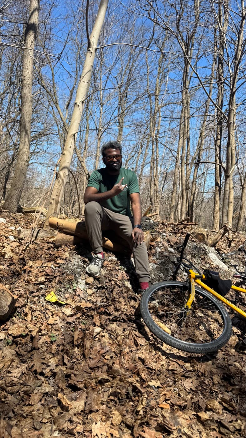 Sitting beside a gravel bike on a woodland trail