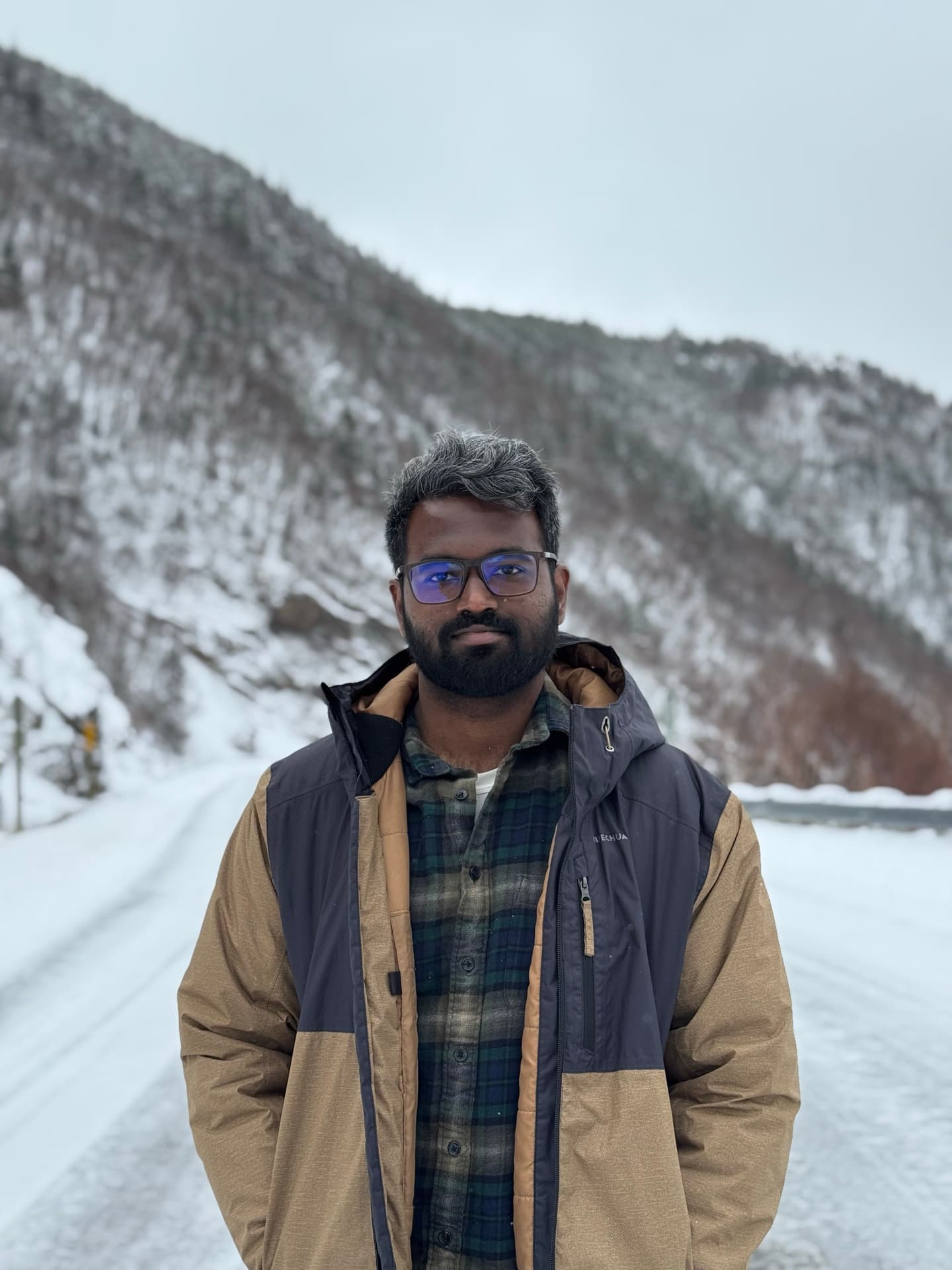 Karthikraj Sivakumar, standing on a snowy mountain road